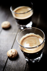 Two Glasses Of Coffee on dark wooden background. Close up.	