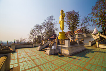 Golden buddha statue stand on mountain temple look to city - 775880280