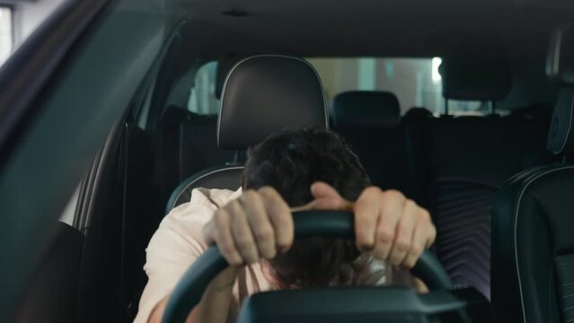 Irritated angry stressed Caucasian business man driver male guy driving electric car stress failure problem inside automobile auto broken traffic jam accident exhausted hitting steering wheel trouble