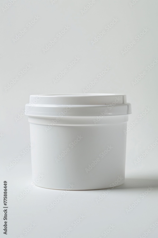 Poster a white container with a lid on a table, suitable for various purposes