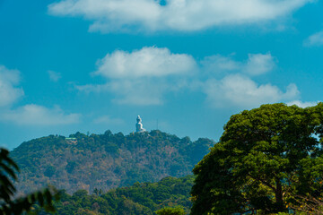 The Phuket Big Buddha statue made of white marble can be seen from a distance among the rows of green hills. Viewed from the top of the hill, Phuket's Big Buddha monument looks majestic and beautiful