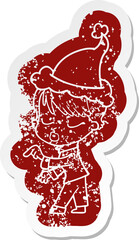 quirky cartoon distressed sticker of a woman with eyes shut wearing santa hat