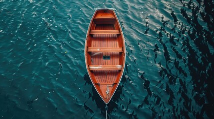 A small wooden boat floating on calm water. Suitable for various nautical themes