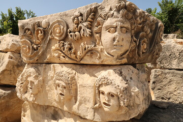 Two stones with elaborate stone reliefs, theater masks and ornaments in the ancient town of Myra,...