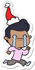 hand drawn sticker cartoon of a man crying wearing santa hat