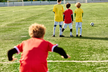 A group of young men stands proudly atop a well-maintained soccer field, their expressions exuding...