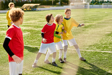 A joyful group of young children stand triumphantly on top of a soccer field, united in victory and...