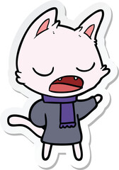 sticker of a talking cat wearing winter clothes