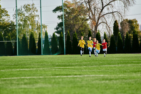 A vibrant group of energetic young children sprinting enthusiastically across a soccer field, filled with joy and excitement as they engage in a playful game.