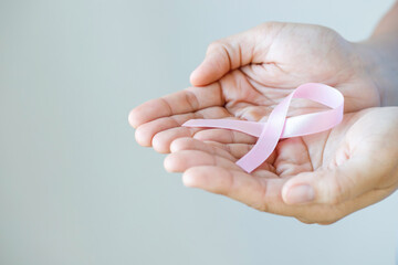 woman with Pink ribbon for patients with breast and cervical cancer