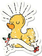 worn old sticker of a tattoo style rubber duck