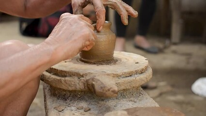 Close-up of hands crafting a clay pot, showcasing the art of traditional pottery in Barangay Cagbang, in the town of Miagao Iloilo, Philippines.