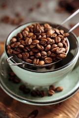 a cup of coffee on a dark background surrounded by coffee beans,