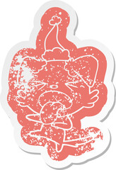 quirky cartoon distressed sticker of a disgusted dog wearing santa hat