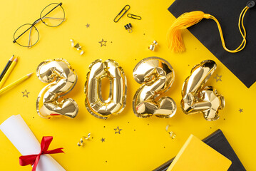 Celebratory top view scene featuring 2024 gold balloons, academic cap, diploma, stationery, books, and confetti on yellow backdrop, perfect for graduation announcements or promotions