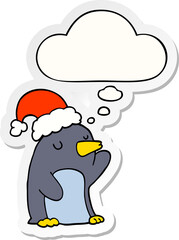 cute cartoon christmas penguin with thought bubble as a printed sticker