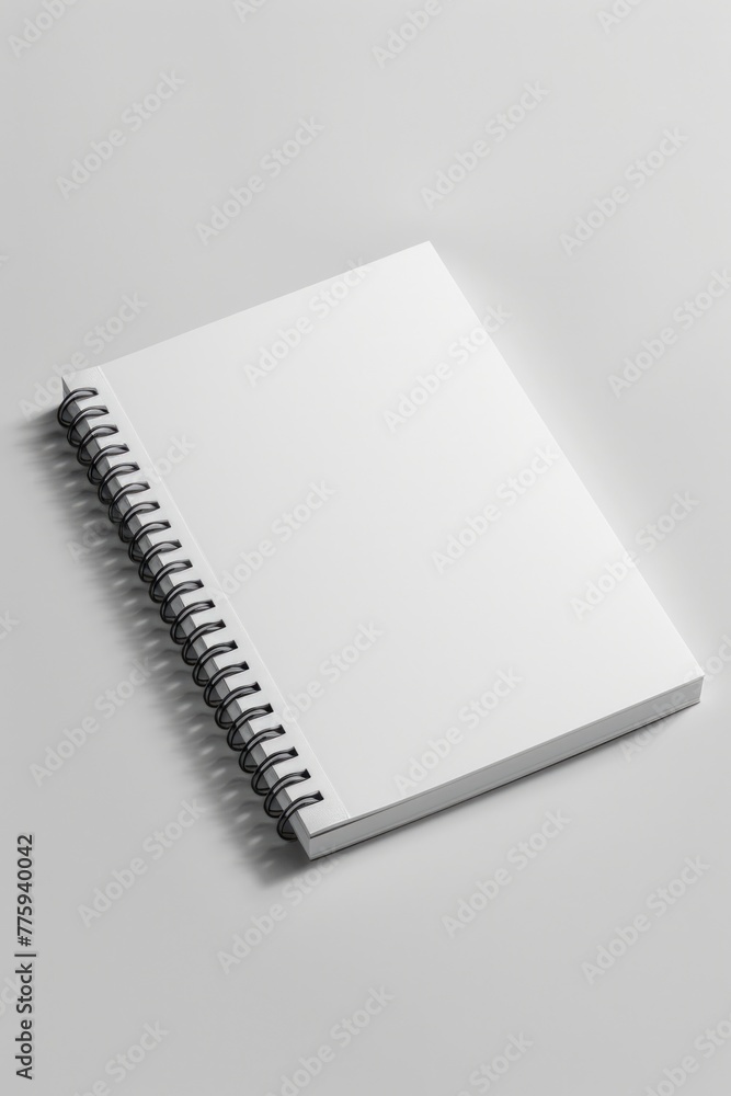 Poster A spiral notebook placed on a white surface. Ideal for office or education concepts