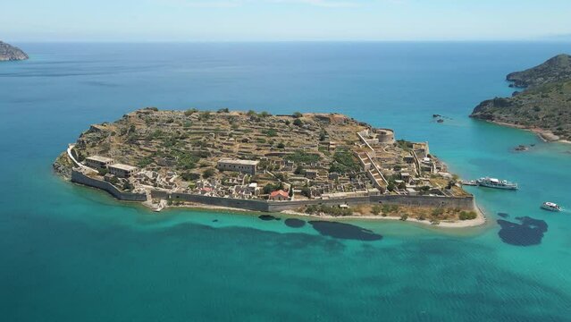 Aerial drone view of Spinalonga island with calm sea. Old venetian fortress island and former leper colony.