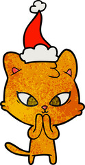 cute hand drawn textured cartoon of a cat wearing santa hat