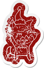happy quirky cartoon distressed sticker of a fox wearing santa hat