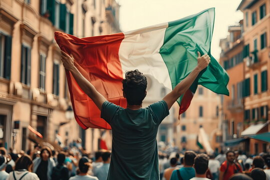 Fototapeta waving italian flag in a crowd on street