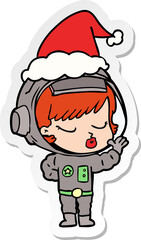 hand drawn sticker cartoon of a pretty astronaut girl wearing santa hat