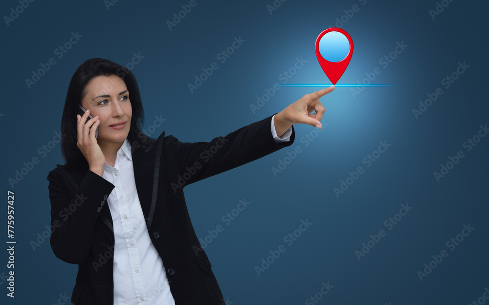 Poster businesswoman talking on her cell phone and pointing finger to map pin point location button over li