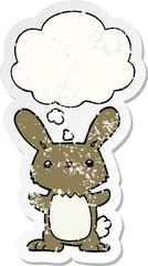 cute cartoon rabbit with thought bubble as a distressed worn sticker