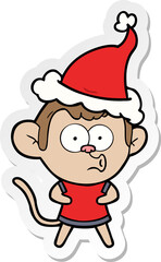 hand drawn sticker cartoon of a surprised monkey wearing santa hat