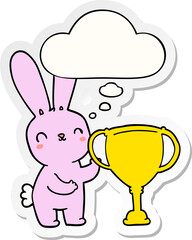 cute cartoon rabbit with sports trophy cup with thought bubble as a printed sticker