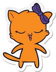 sticker of a cartoon cat with bow on head
