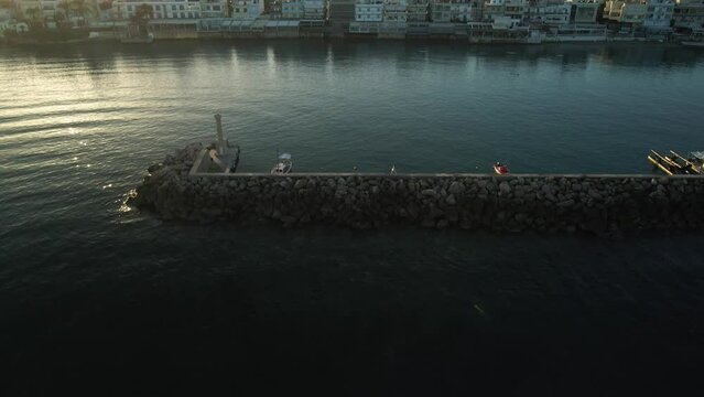 Aerial top view by drone of a harbor of the famous resort Chersonissos on Crete, Greece during sunset.