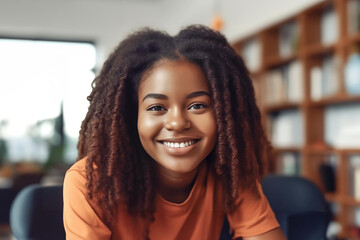 black student girl sitting in a school library with bookshelves in the background