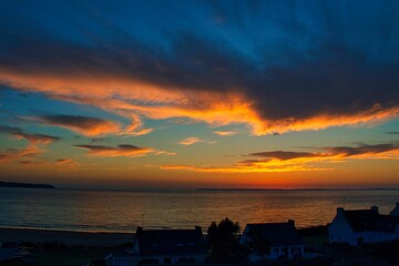 Epic sunset over the Atlantic sea from Plonevez-Porzay beach in Bretagne, France