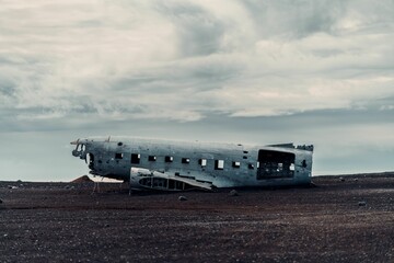 Old crashed plane in Solheimasandur beach with a dramatic sky in the background, Iceland