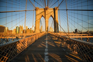 Daytime view of the Brooklyn bridge in the early morning with sunshine on it in New York