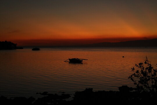 Fisherman boat approaches the night, Siquijor.