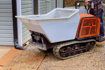 Utilization of self dumping rubber track concrete truck for transporting concrete at construction...