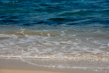 Wavelets washing up on the sunny beach
