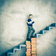 Boy climbing staircase of books toward success
