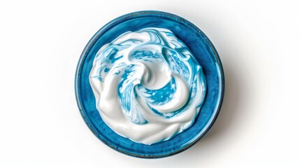A simple yet appealing image of fresh Greek yogurt or sour cream in a blue ceramic bowl