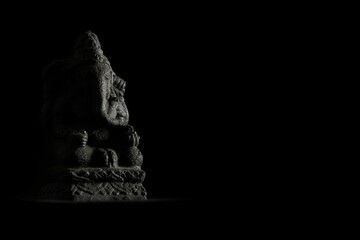 Closeup shot of a miniature Ganesha statue on the black background
