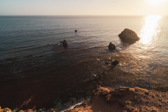 sunset over the sea at the coast of Paracas Peru