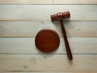 Top view of a Judge's hammer on a wooden background - the concept of jurisdiction - obrazy, fototapety, plakaty