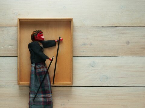 Top view of a Cepot traditional puppet figure on a wooden background