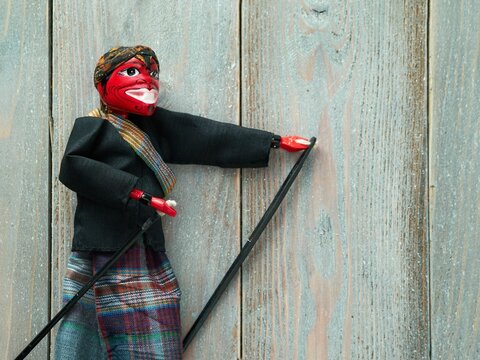 Top view of a Cepot traditional puppet figure on a wooden background