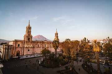 view over the main square and white stone church in Arequipa at sunset