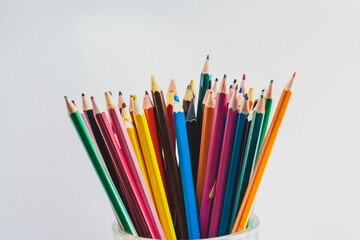 Set of color pencils against a white background