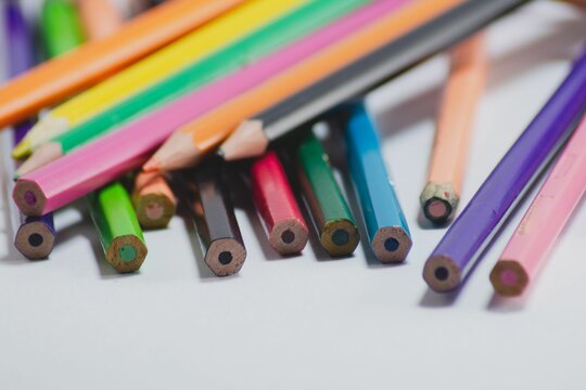 Closeup of stack of colorful wooden pencils isolated on white background
