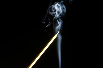 Closeup of colorful pencil and white smoke on a black background